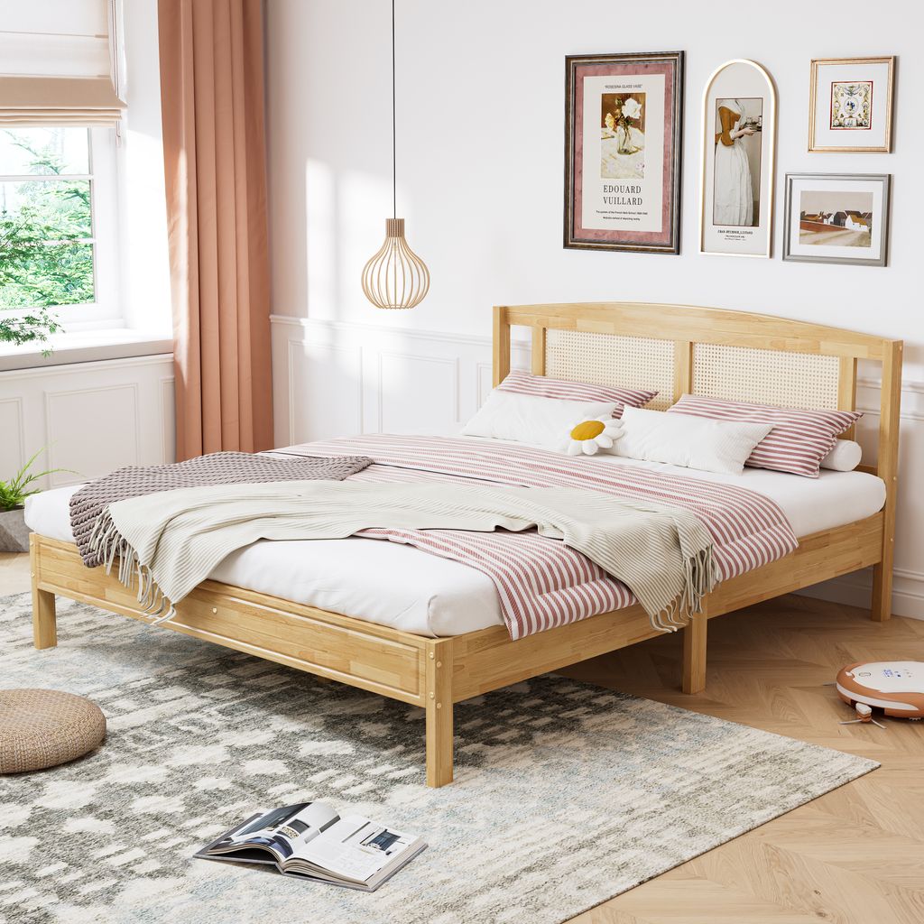 A bedroom scene with a wooden bed and bedding.