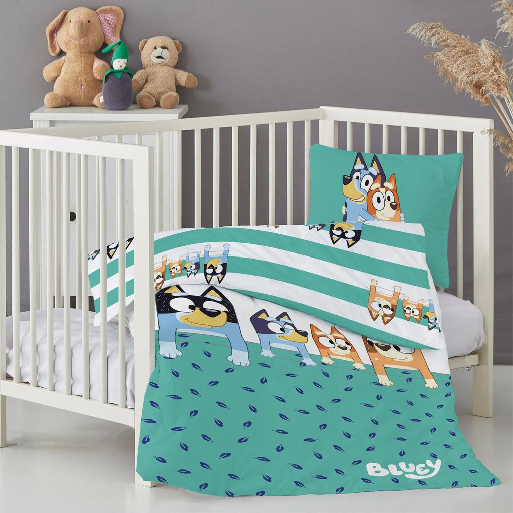 A Bluey-themed baby bedding set is displayed in a white crib, with stuffed animals on a shelf above.