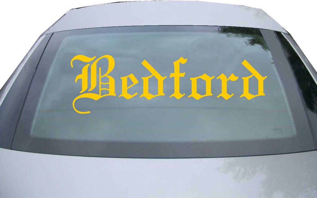Indigos UG - Aufkleber Heckscheibe & Motorklappe DE6596 - gold - 600x180 mm - Bedford - Auto Scheiben Fenster Heckklappe Tuning Racing JDM - Die cut