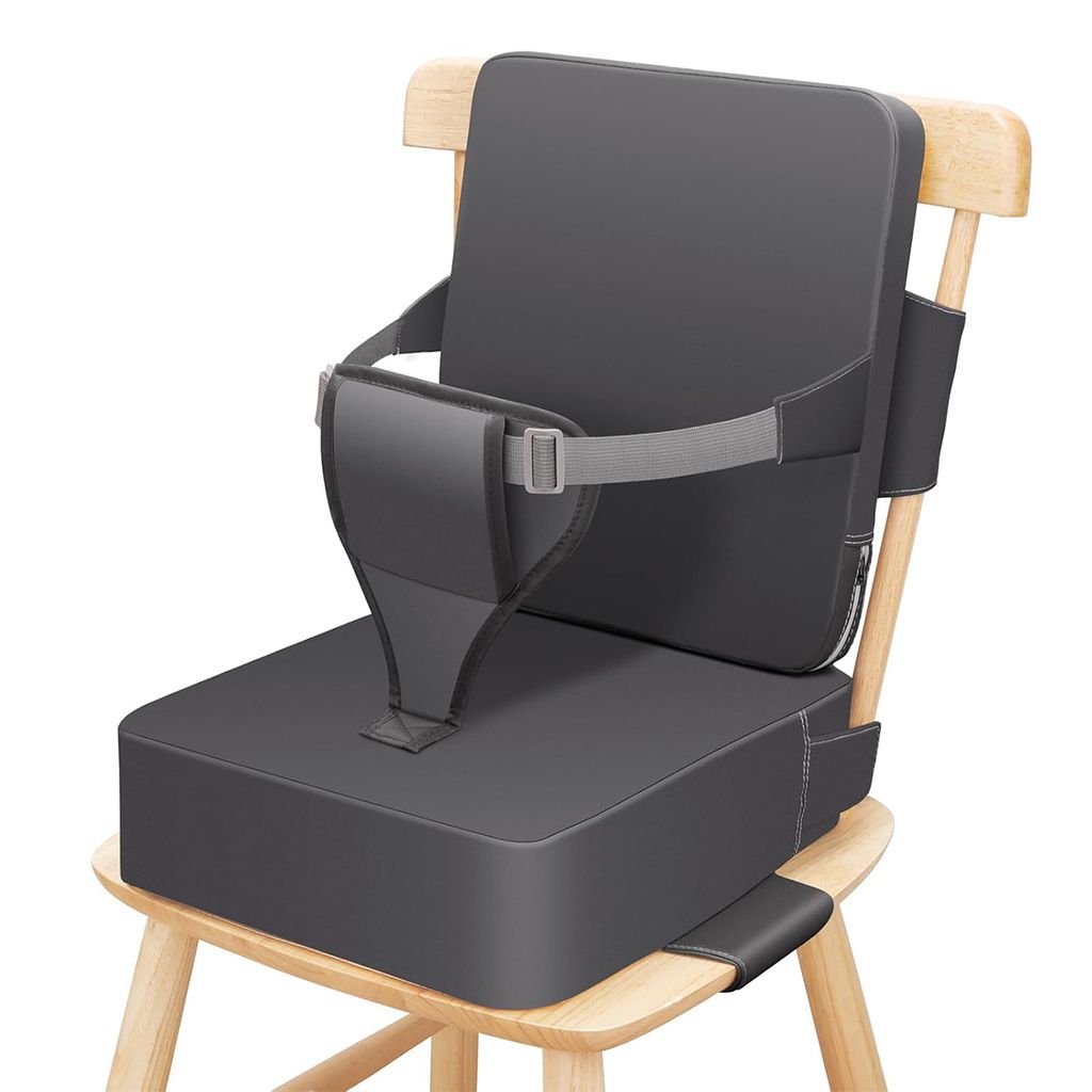 A gray toddler booster seat is placed on a wooden chair.