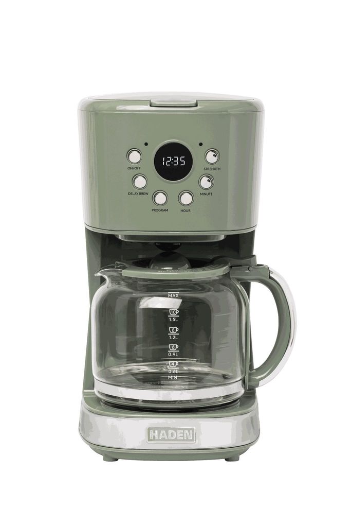 A green coffee maker with a glass carafe on a white background.