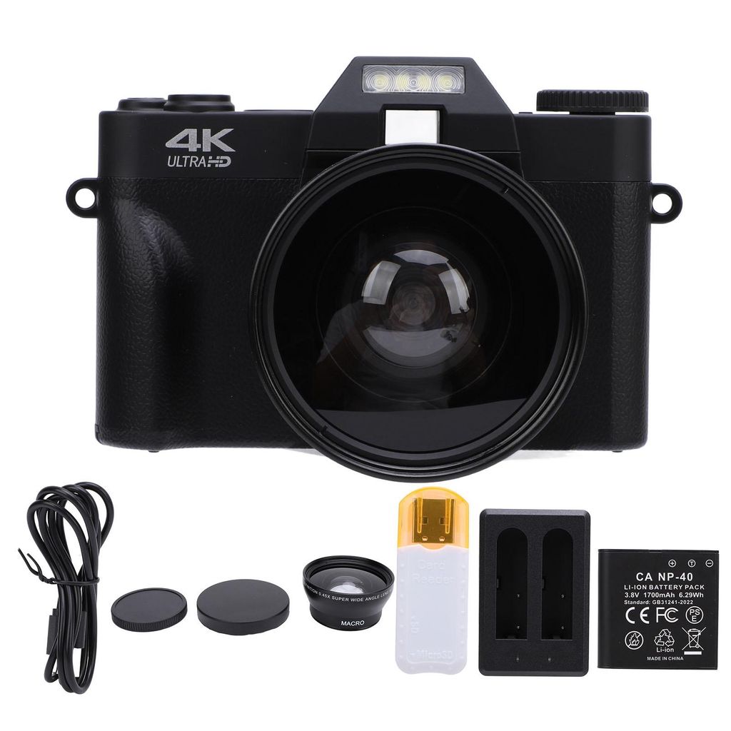 A black digital camera with accessories laid out below it on a white background.