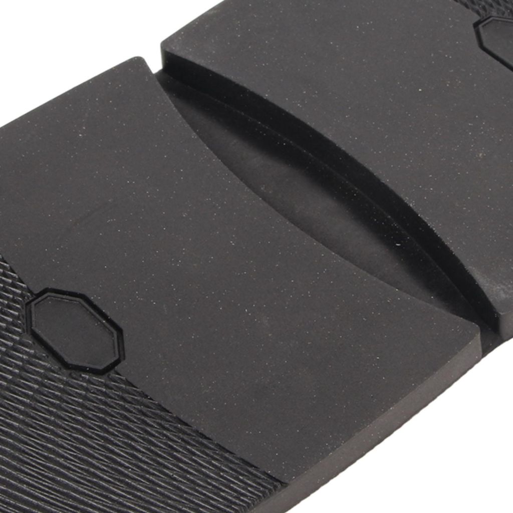 A close-up view of the textured sole of a shoe, showing the material and a small hexagonal detail.