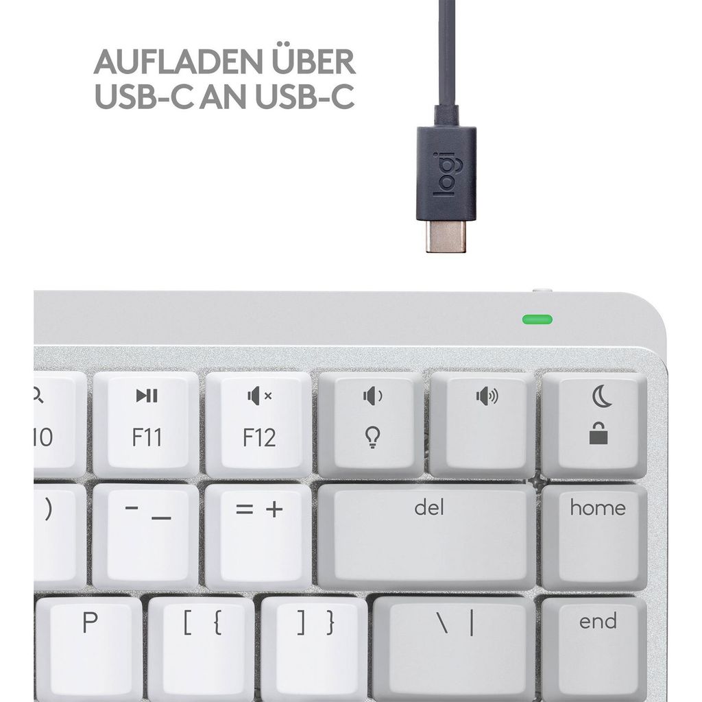 A close-up view of a white keyboard with a USB-C cable and connector.