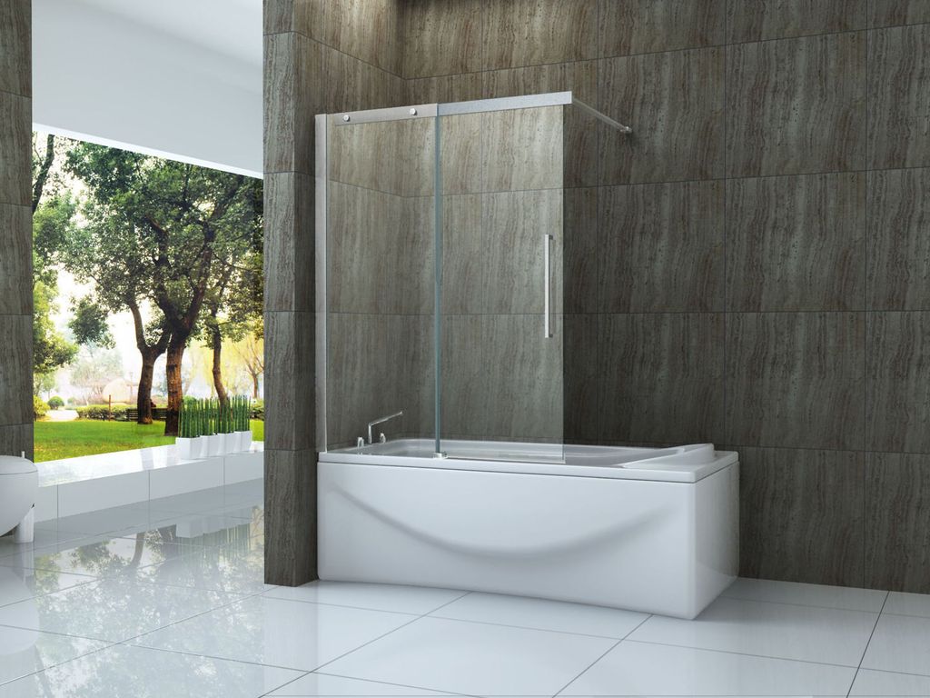 A modern bathroom with a bathtub and a glass shower screen, overlooking a garden.