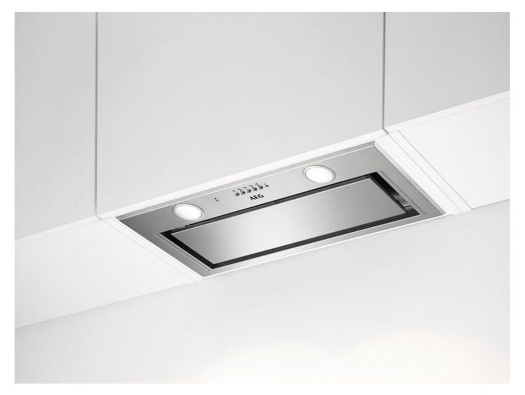 A built-in kitchen range hood mounted under white cabinets.