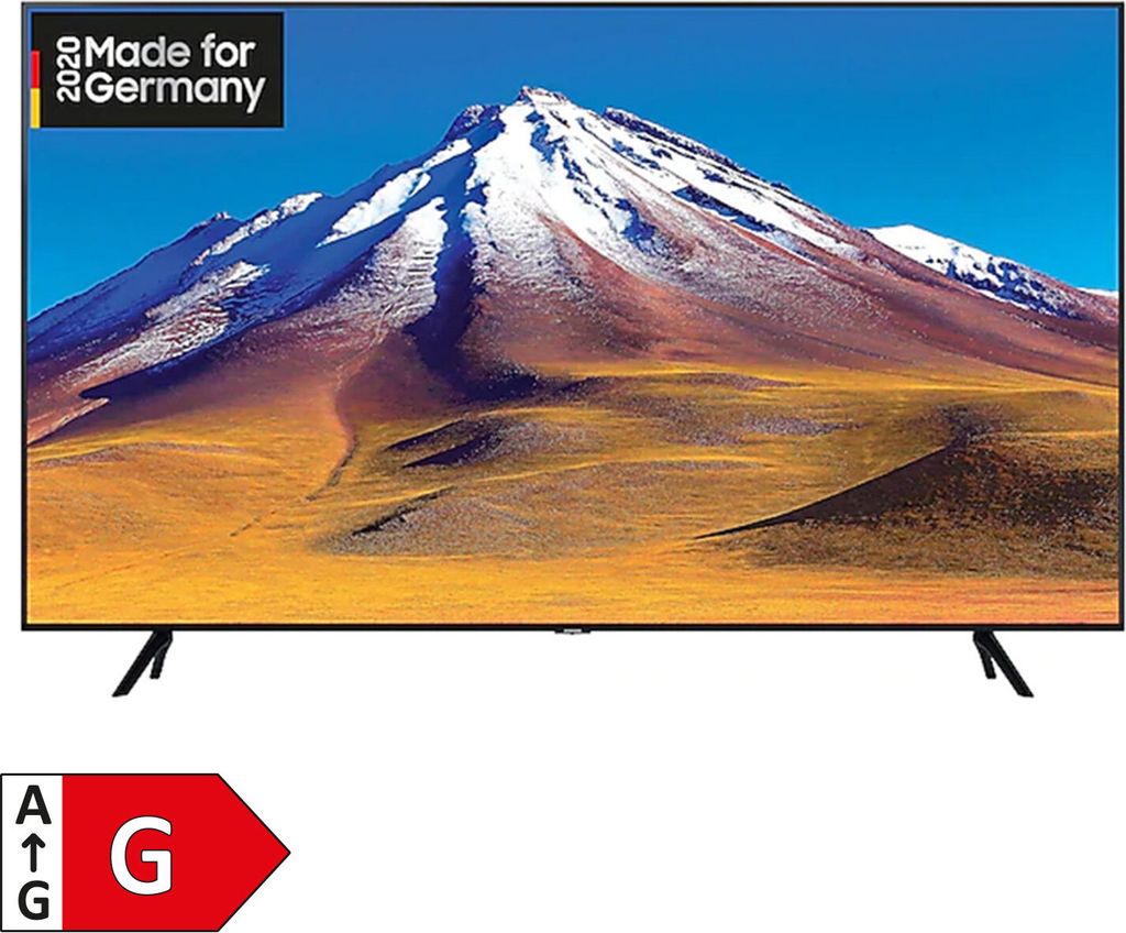 A Samsung television displaying a mountain landscape, with an energy efficiency label and a "Made for Germany" badge.