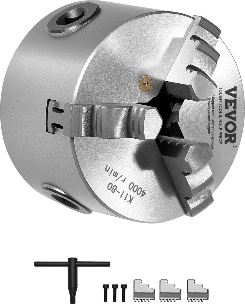 A metal lathe chuck with accessories on a white background.