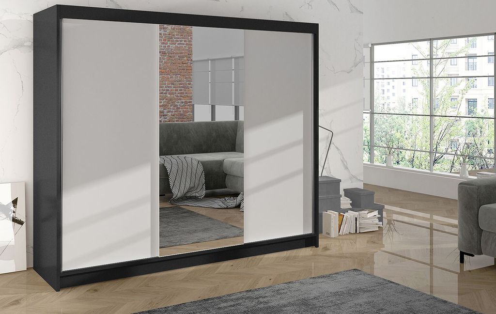 A modern bedroom with a large mirrored wardrobe.