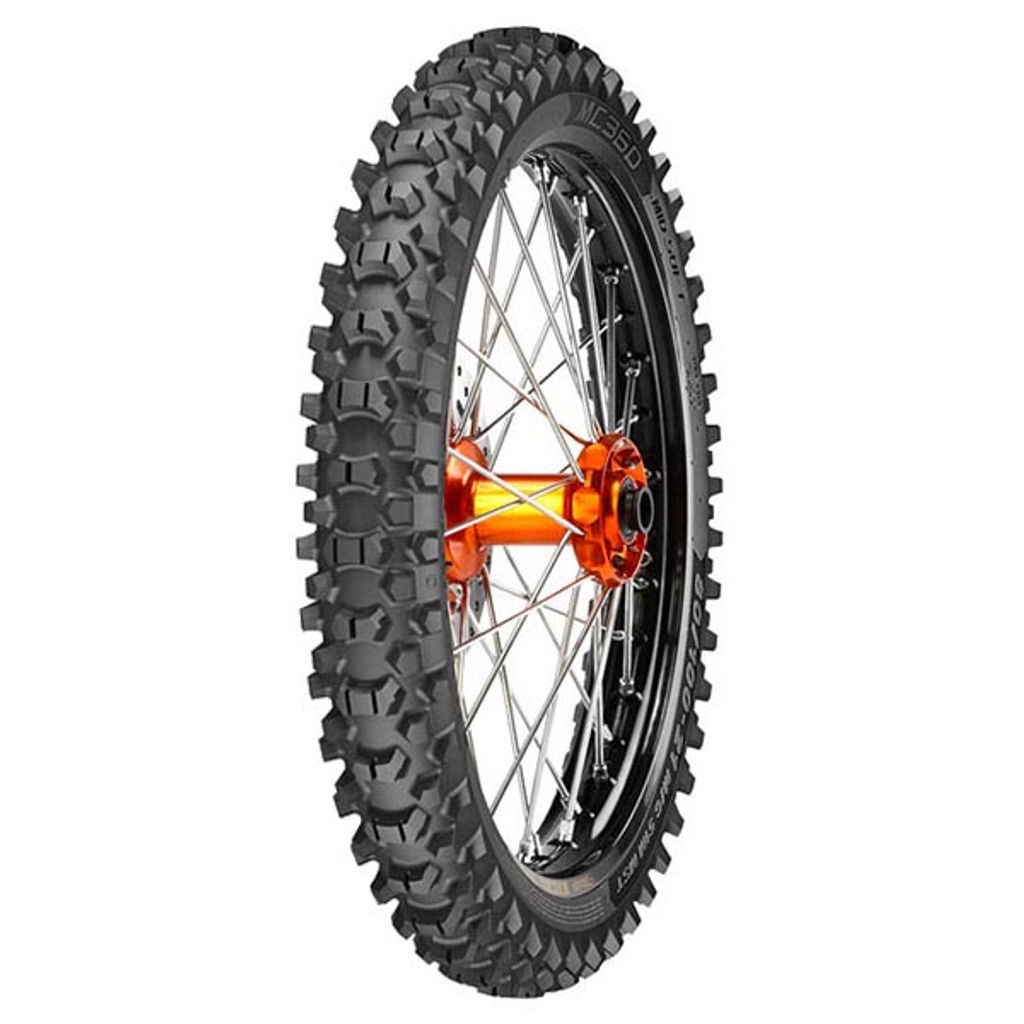 A motocross tire on a wheel, presented against a white background.