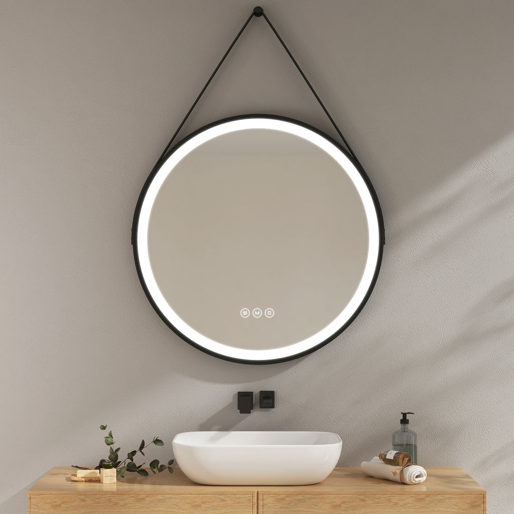 A round LED mirror hangs above a sink in a bathroom.