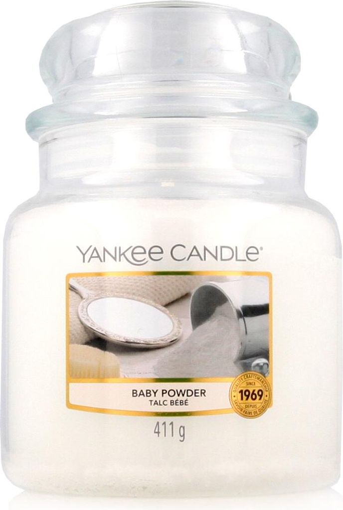 A Yankee Candle jar with a label showing a baby powder theme.