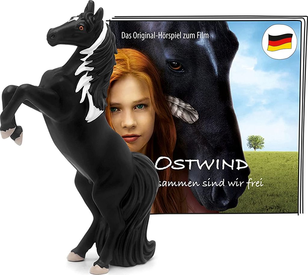 A toy horse figure is in the foreground, with a movie poster or cover art in the background featuring a girl and a horse.