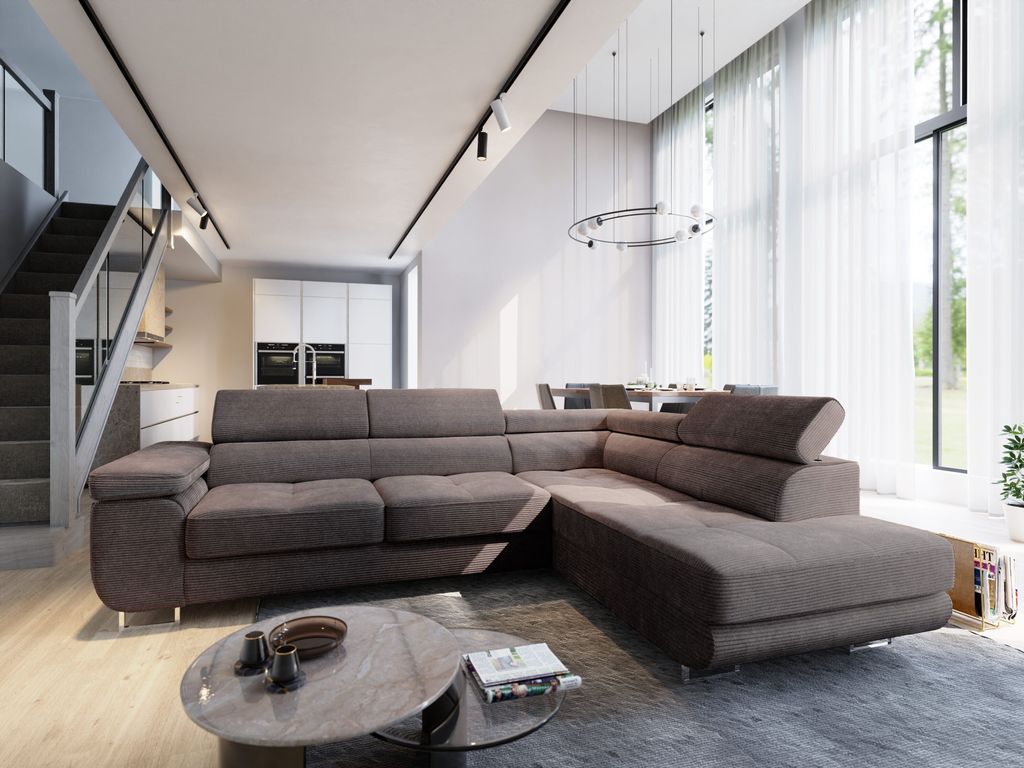 A modern living room with a large sectional sofa, coffee table, and stairs leading to an upper level.