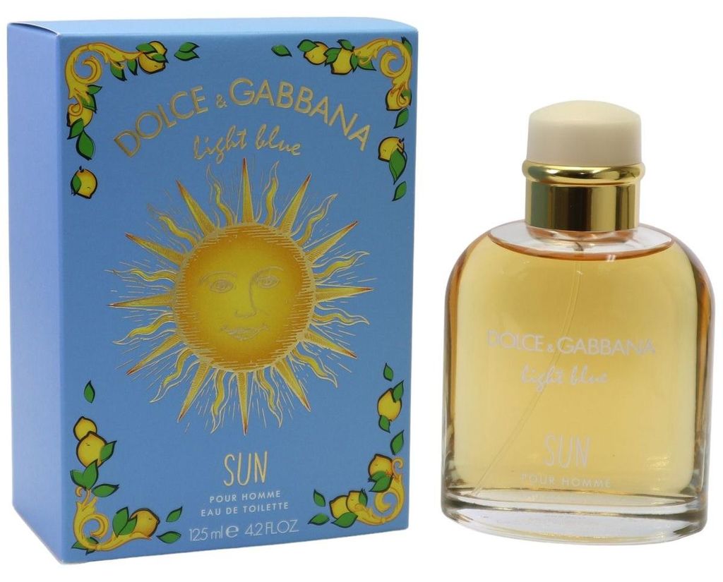 Hellblaue Duftbox mit goldener Sonne und Zitronenmotiv, daneben runder Glasflakon mit honigfarbenem Inhalt und cremeweißer Kappe.