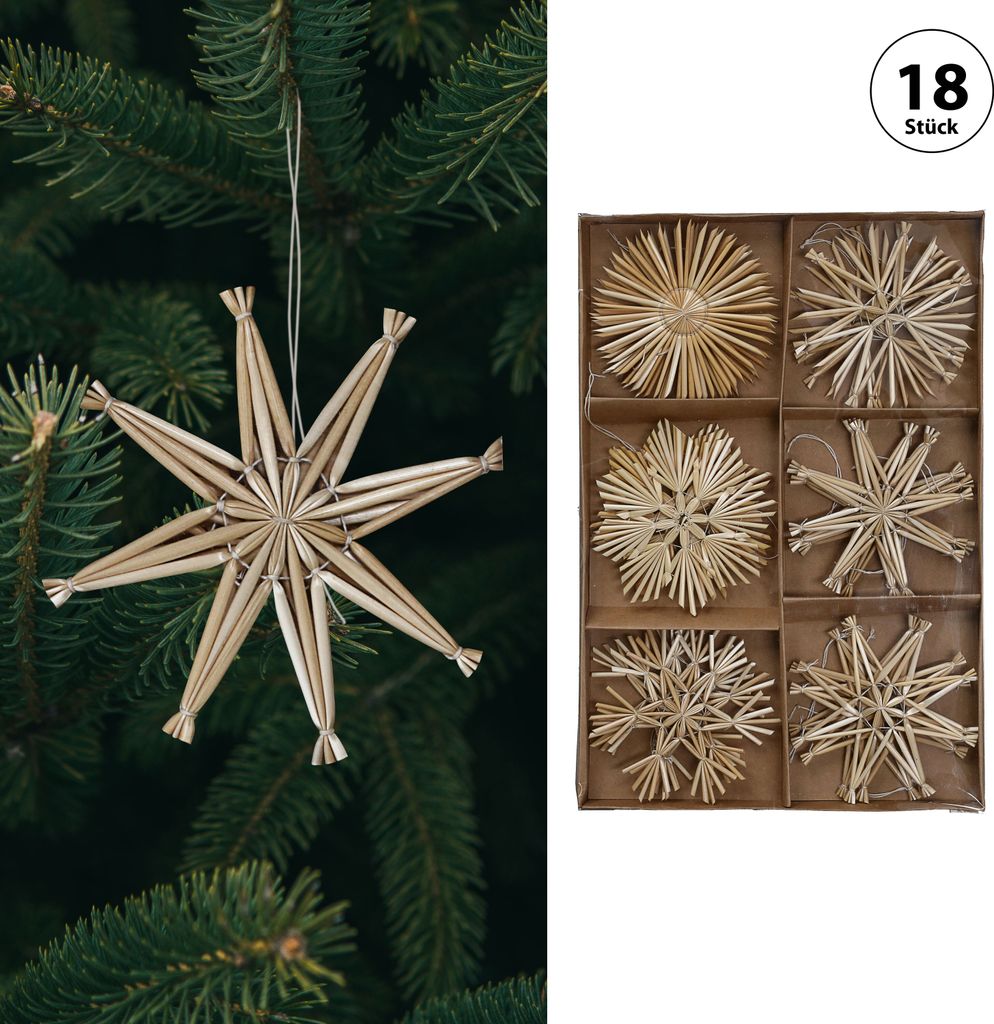 A Christmas tree branch with a straw star ornament, and a box of assorted straw star ornaments.