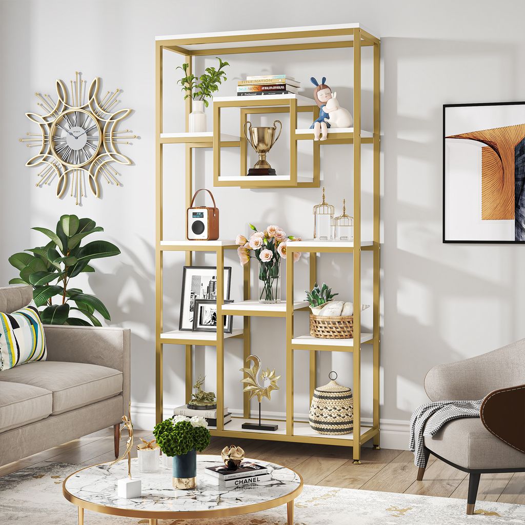 A living room scene featuring a gold and white bookshelf filled with decorative items.