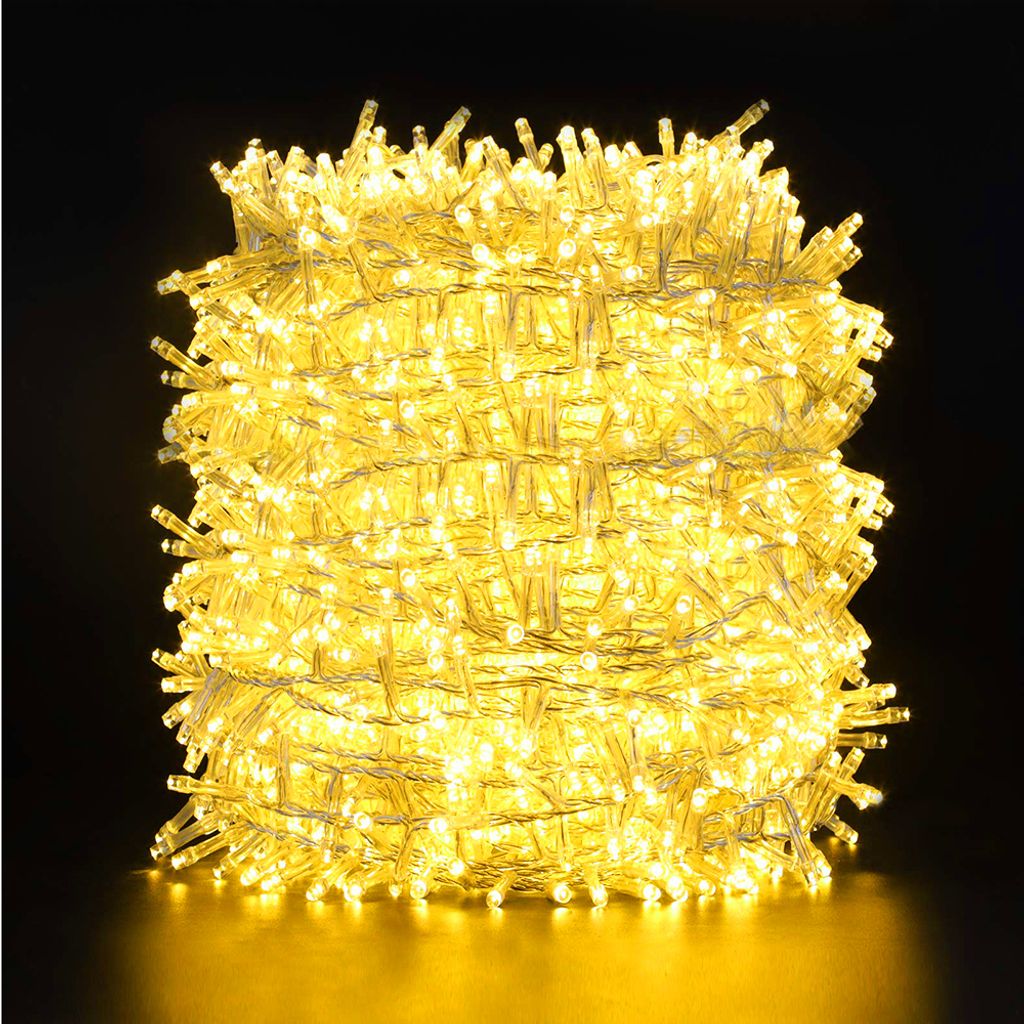 A tightly wound coil of yellow LED string lights against a black background.