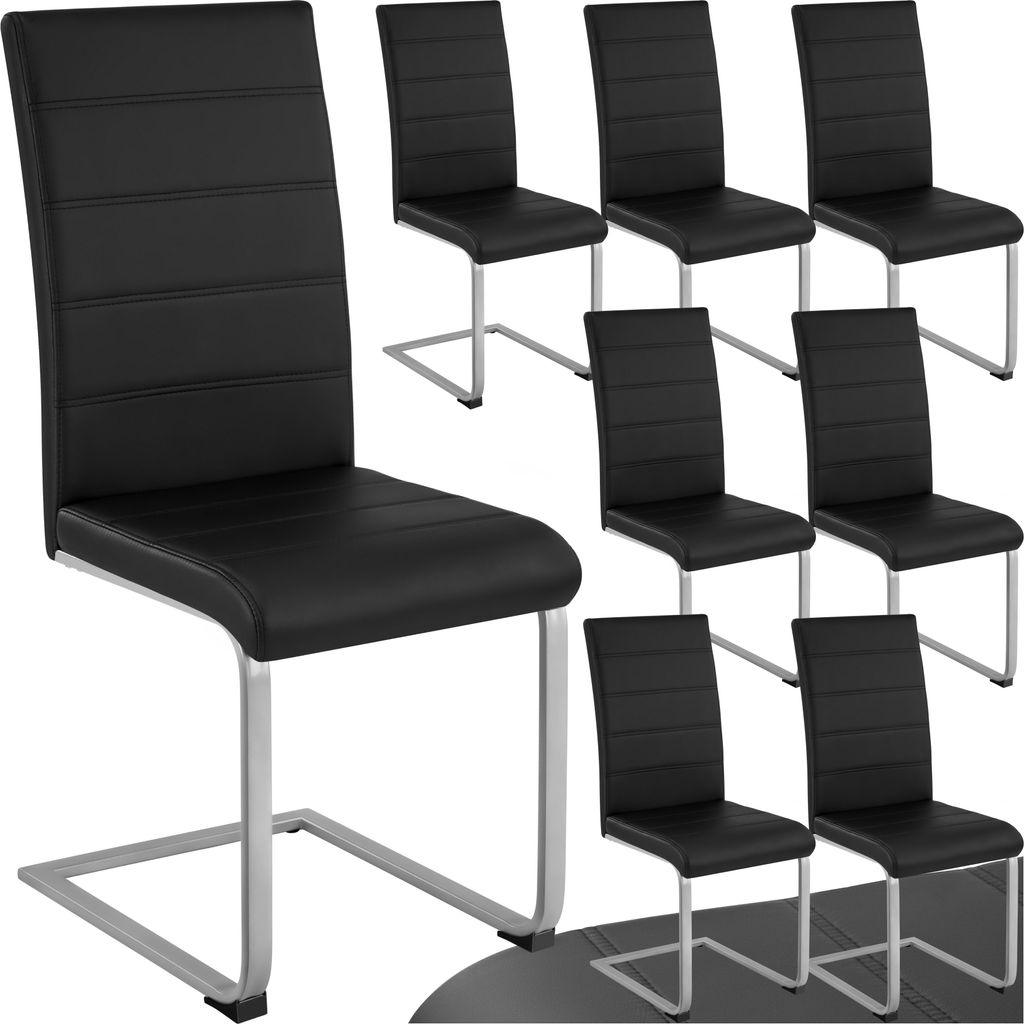 A set of black dining chairs with silver legs arranged on a white background.