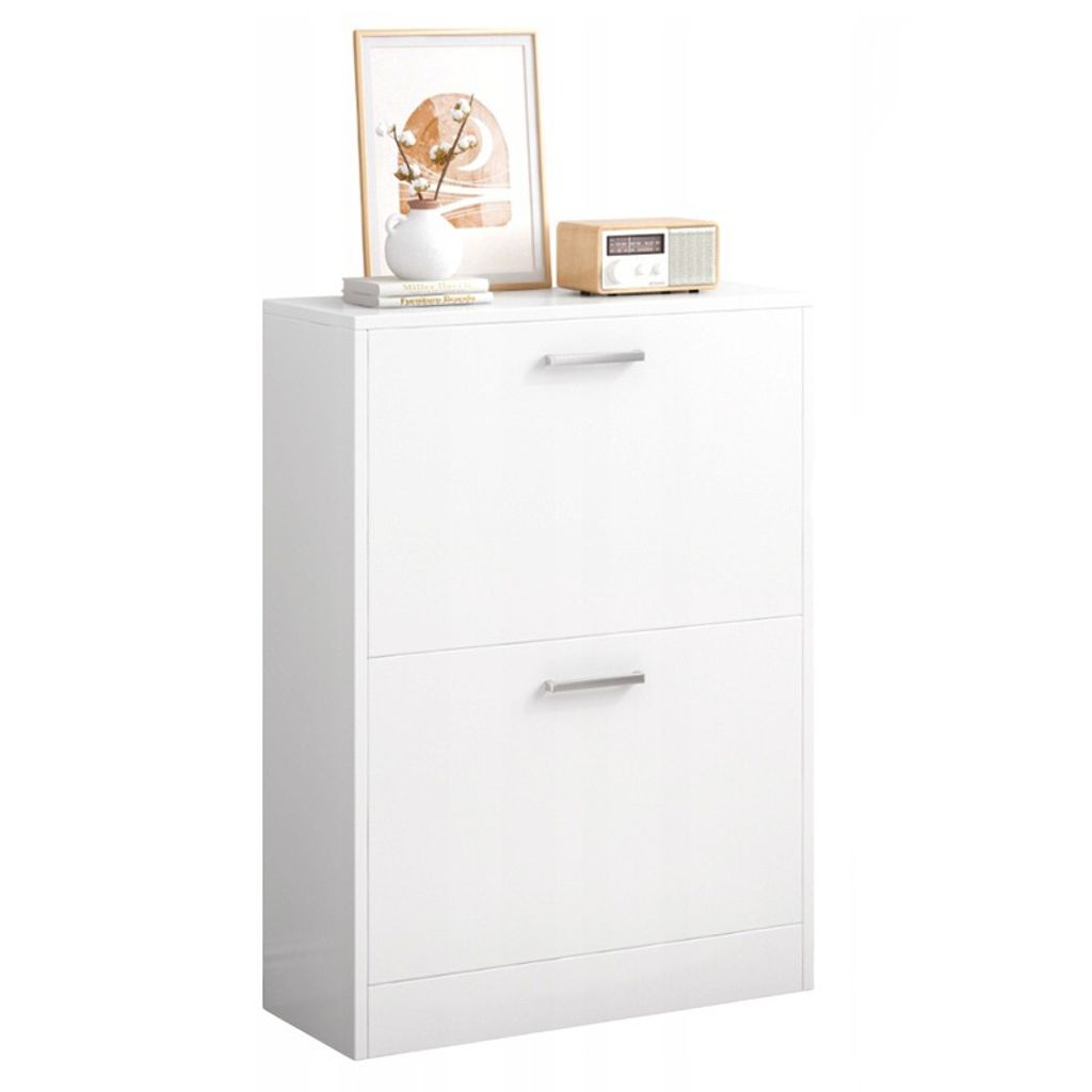 A white shoe cabinet with two drawers is shown against a white background. Decorative items are placed on top of the cabinet.