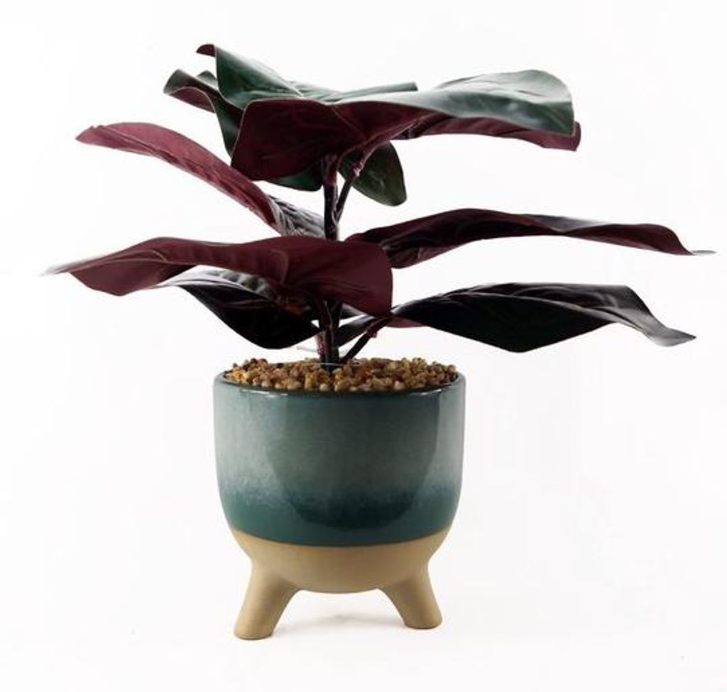 Kunstblume mit großen Blättern, realistisch, in einer großen Pflanzervase