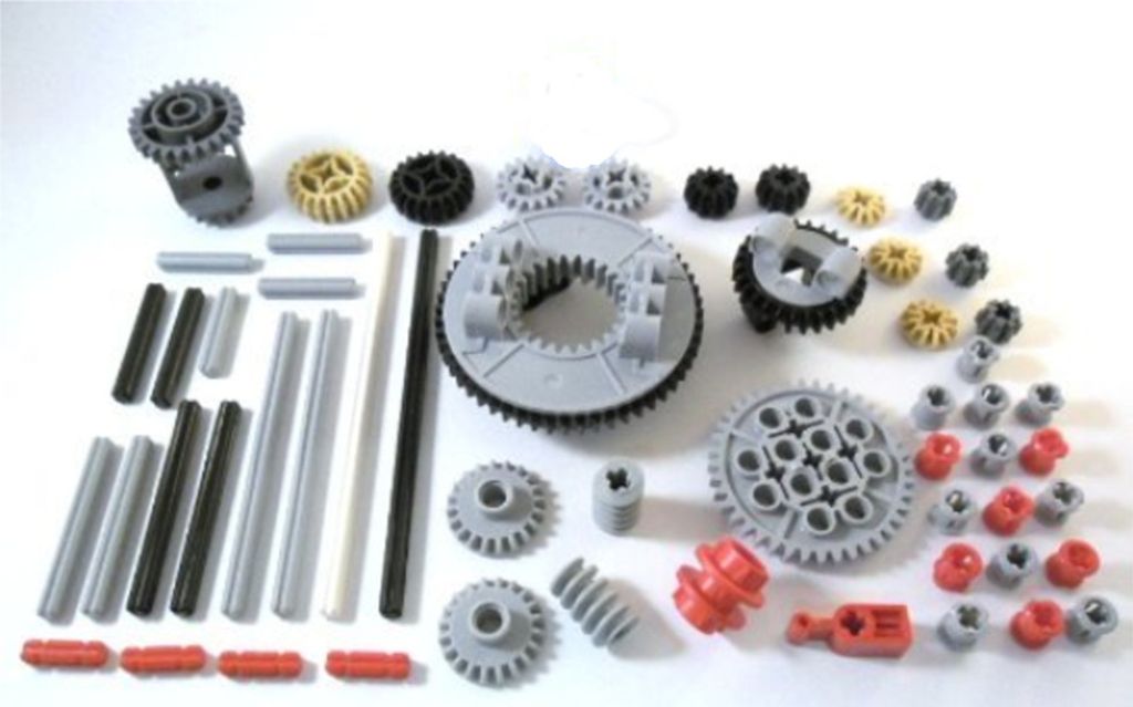 A collection of LEGO Technic gears and connecting pieces arranged on a white background.