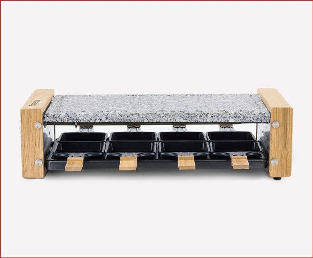 A raclette grill with a granite stone top and eight individual cooking pans.