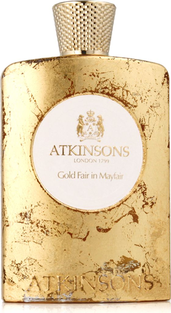 A perfume bottle with a gold-colored, textured exterior and a white label.