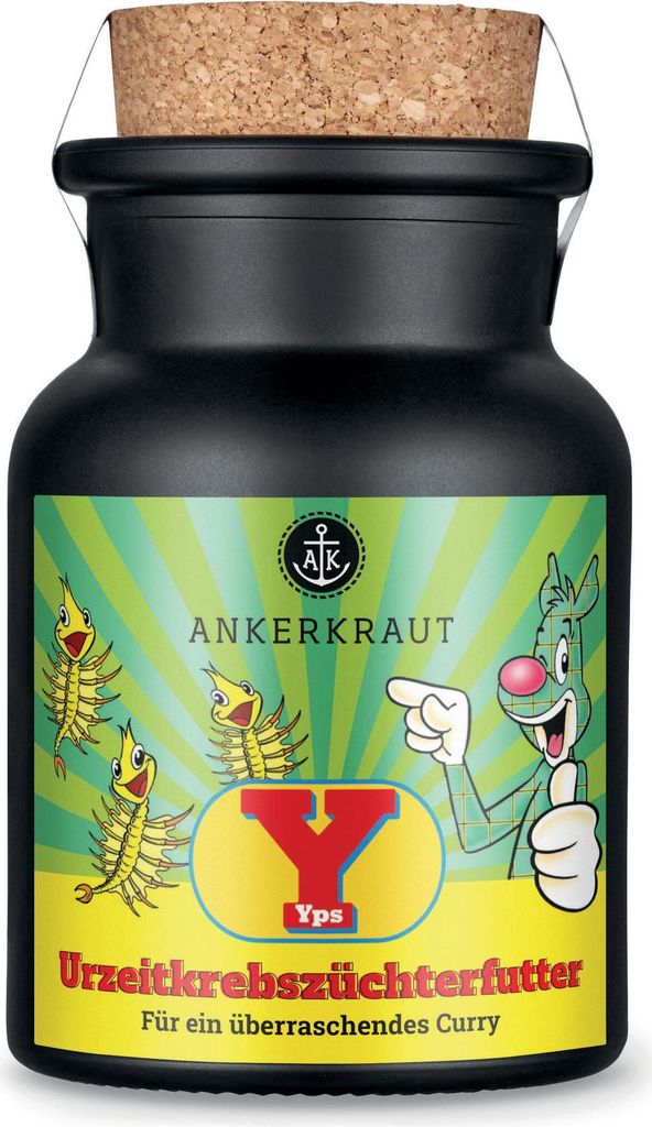A black jar with a cork lid, labeled with a cartoon character, small shrimp-like creatures, and text.