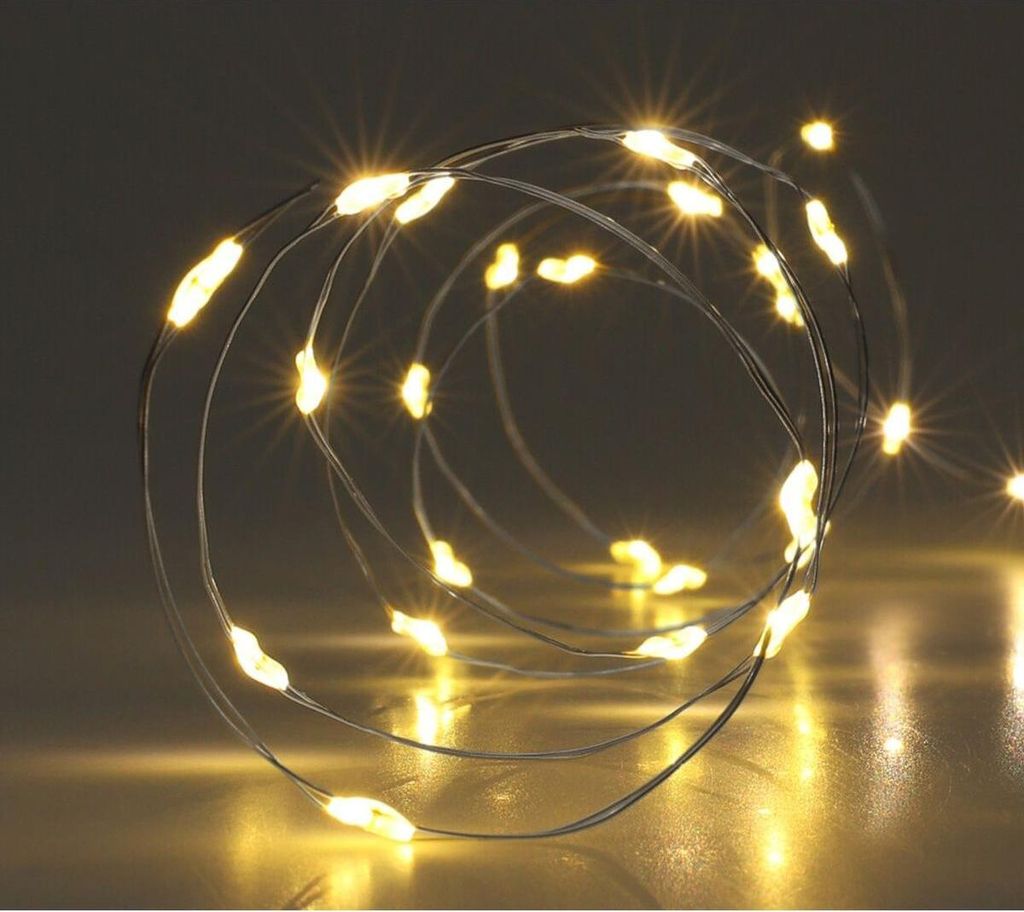 A coiled string of warm white LED lights on a thin wire.