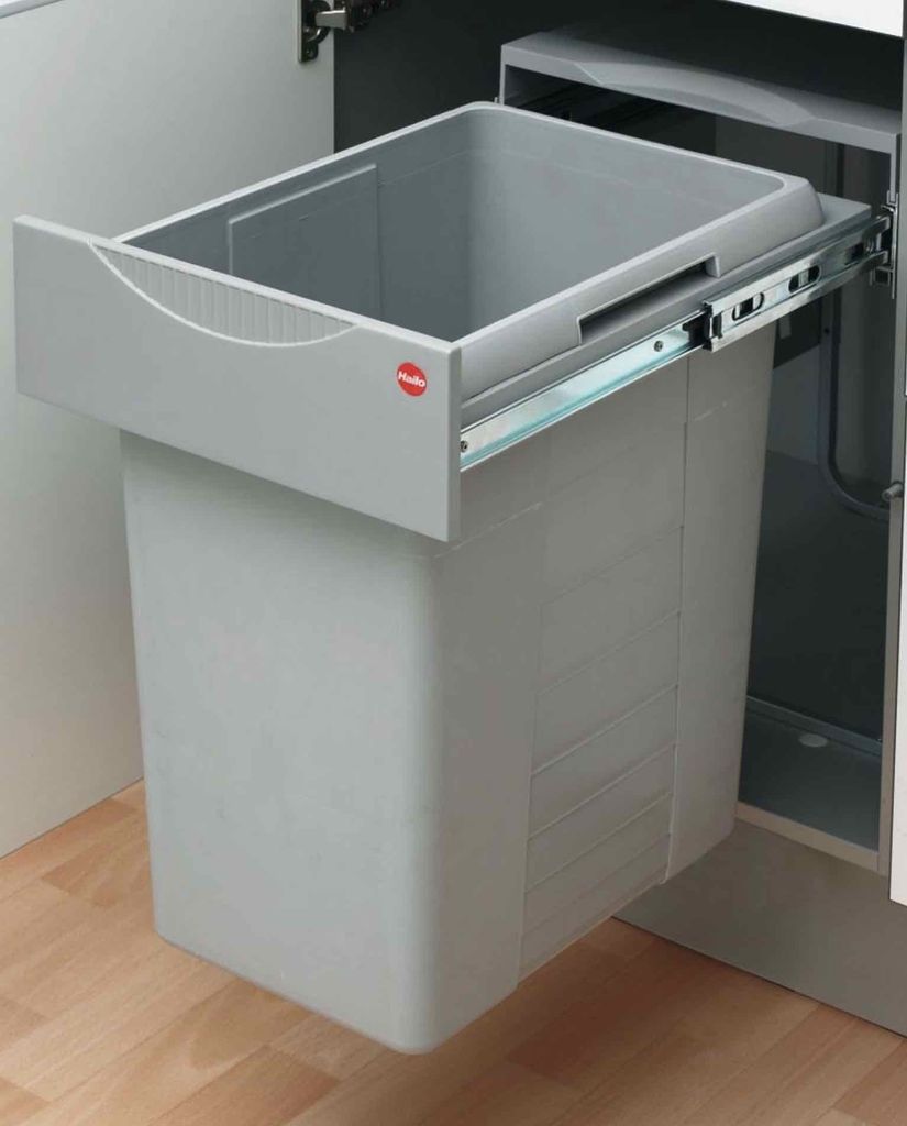 A pull-out trash bin system installed inside a cabinet.