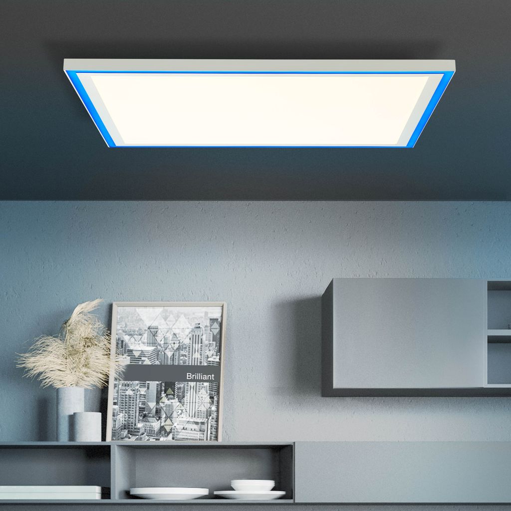 A modern LED panel light with a blue frame is mounted on a dark gray ceiling above a shelf with decorative items and framed artwork.