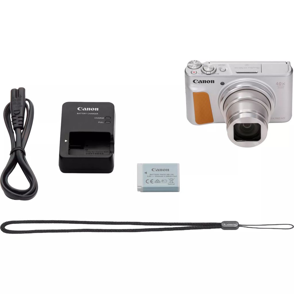 A collection of camera accessories, including a camera, charger, battery, and strap, laid out on a white background.