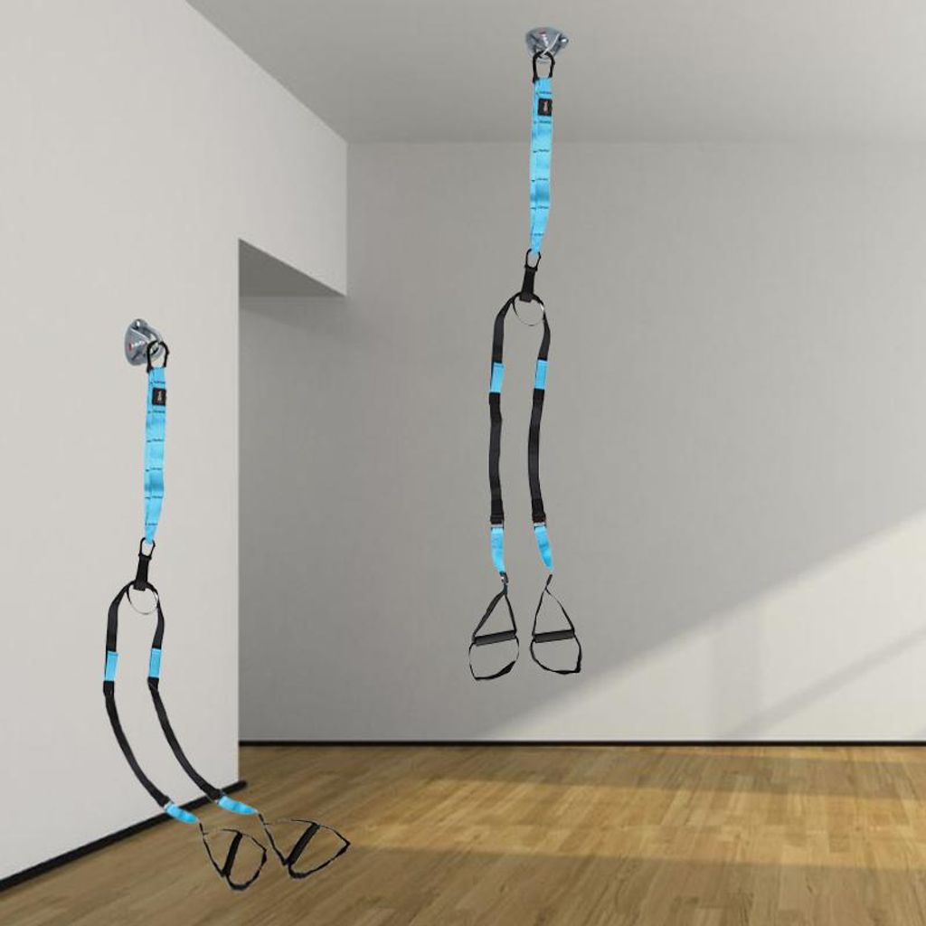 Two sets of suspension training straps are shown hanging from the ceiling and a wall mount in a room with wooden floors and white walls.