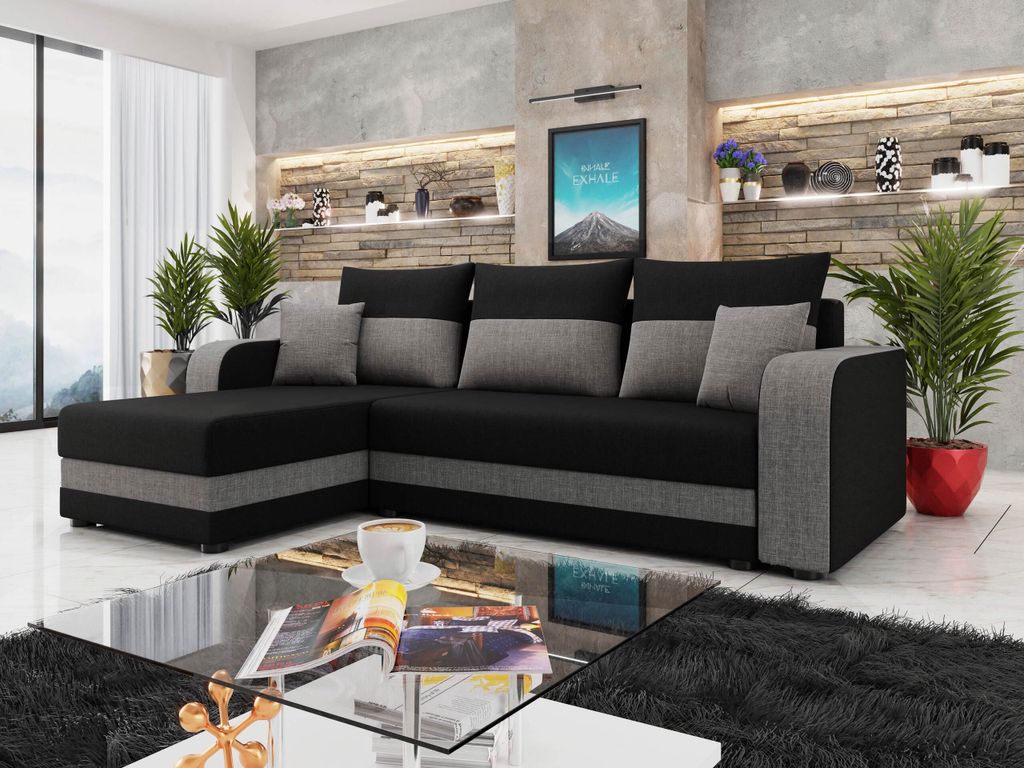 A modern living room with a sectional sofa, coffee table, and decorative elements.