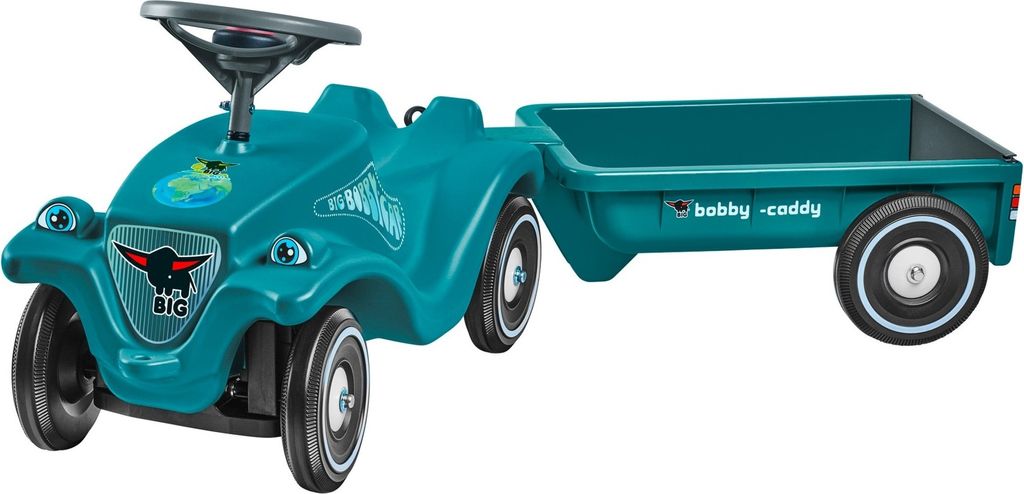 A teal ride-on toy car with a trailer, shown from a 3/4 front angle against a white background.