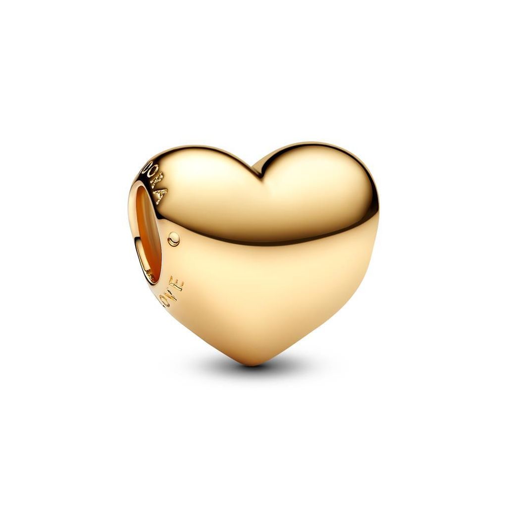 A close-up studio shot of a gold heart-shaped charm.