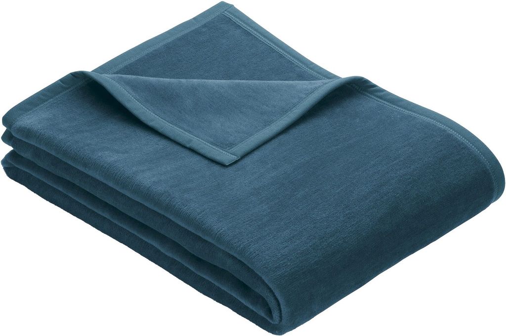 A folded teal blanket is shown on a white background.