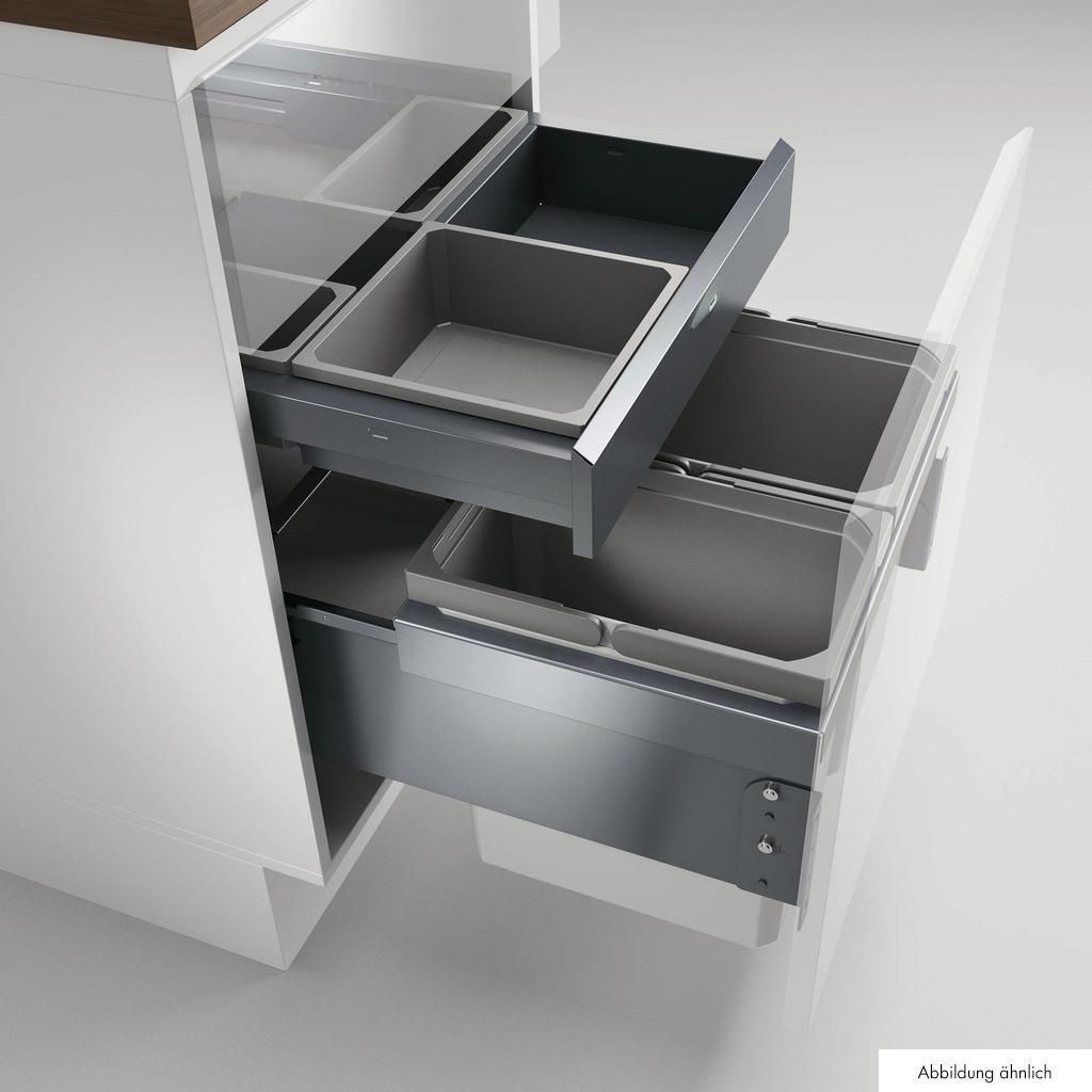 A kitchen cabinet with pull-out drawers containing waste bins.