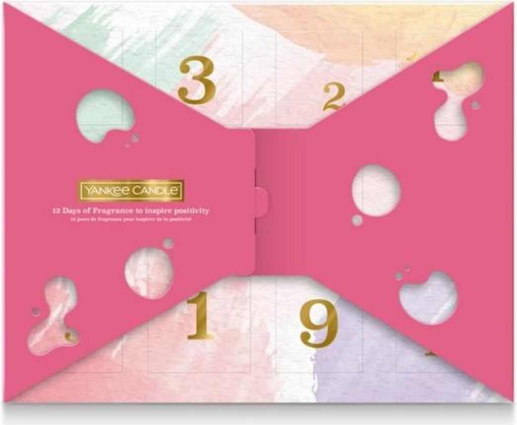 A pink advent calendar with cut-out shapes and gold numbers, designed to look like a bow tie.