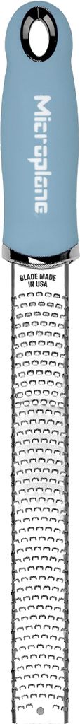 A close-up, top-down view of a Microplane grater against a white background.