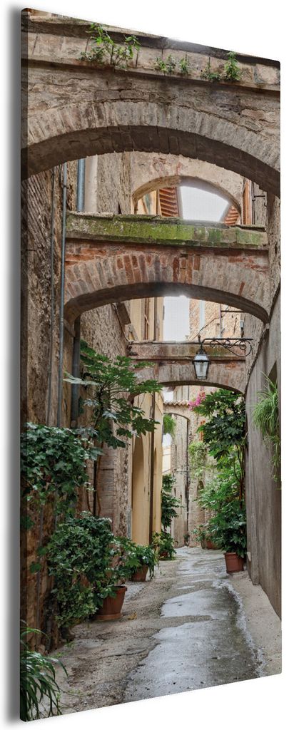 Wallario Premium Leinwandbild Grüne italienische Gasse - mit alten Bögen in Größe 50 x 125 cm