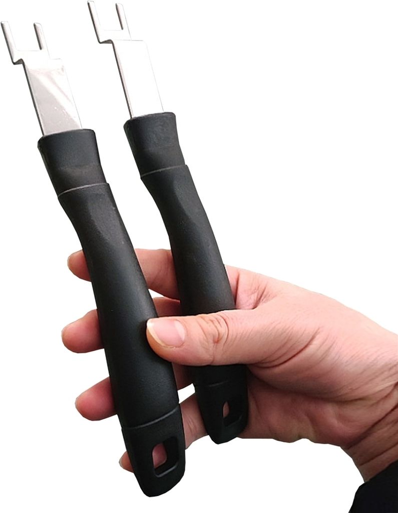 A hand holding two black grill handles with silver metal ends.