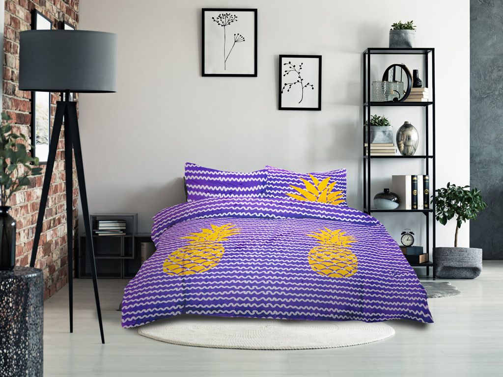 A bedroom scene with a bed dressed in purple and yellow pineapple-patterned bedding.