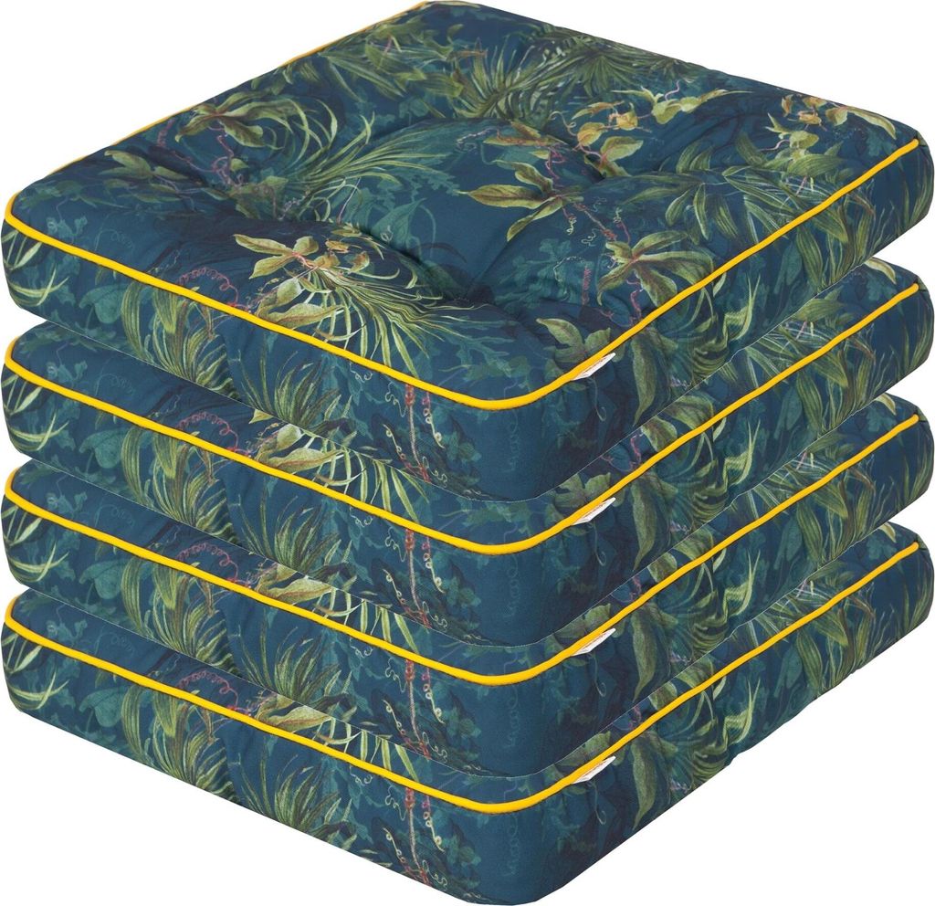 A stack of four square cushions with a tropical leaf pattern and yellow piping.