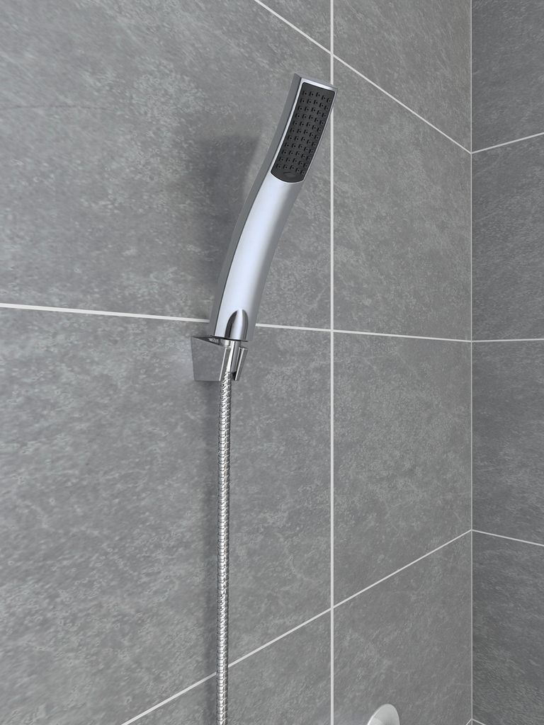 A close-up shot of a modern hand shower head mounted on a tiled wall.