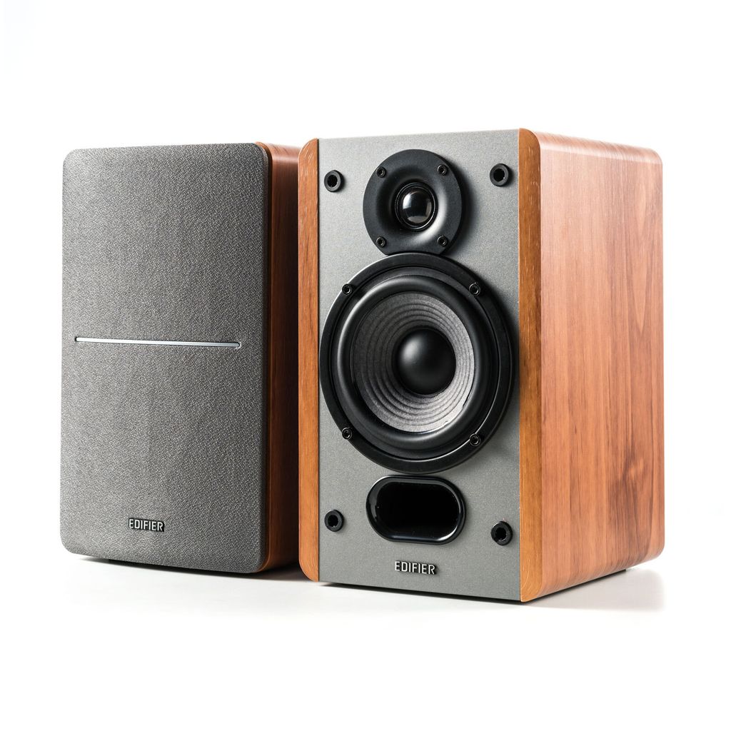 A pair of Edifier P12 passive bookshelf speakers are shown against a white background. One speaker is in the foreground, showing its front panel with a tweeter, woofer, and bass reflex port. The other speaker is positioned to the left, with its fabric gril
