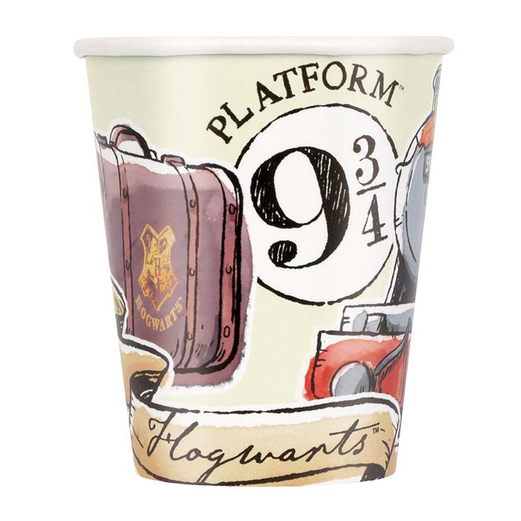 A close-up view of a Harry Potter-themed paper cup, featuring illustrations of a suitcase, the Hogwarts crest, and the iconic Platform 9 ¾ sign.
