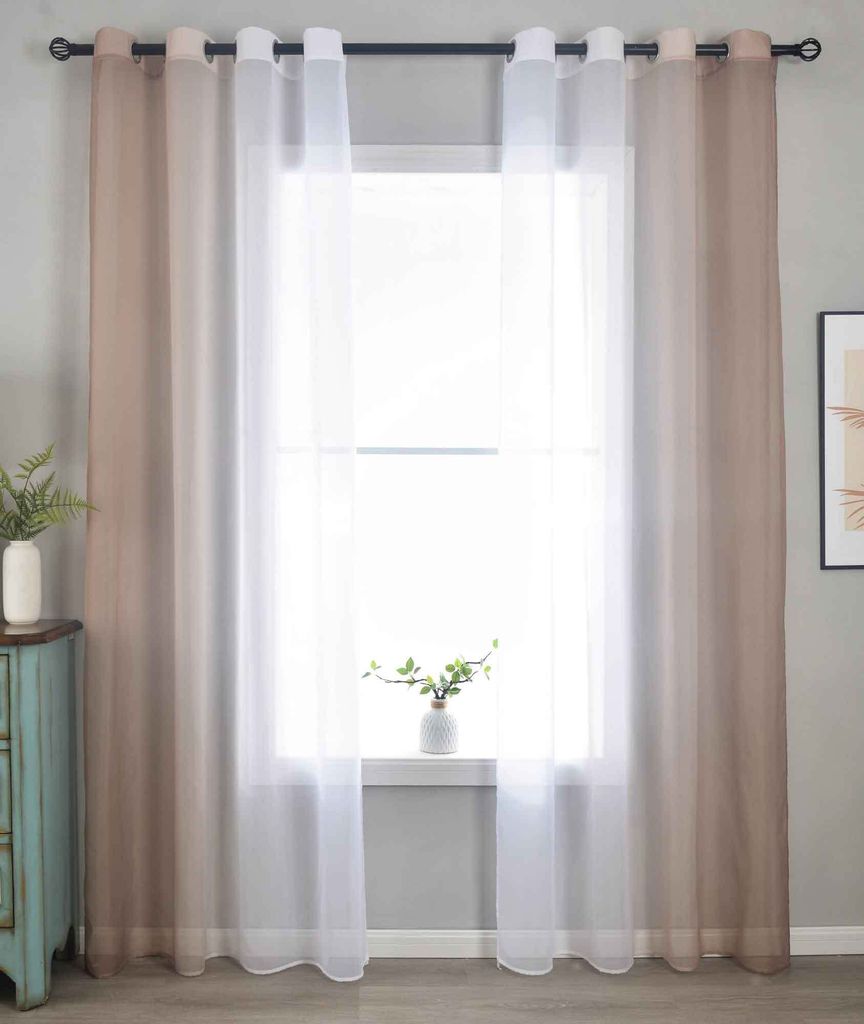 A window with curtains and a small plant on the windowsill.