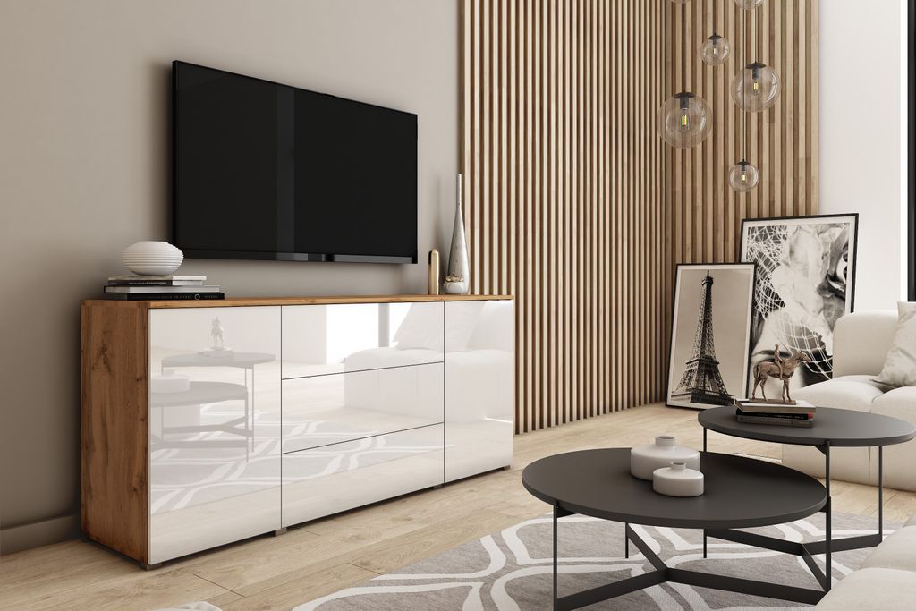 A modern living room with a TV stand, TV, coffee tables, and artwork.